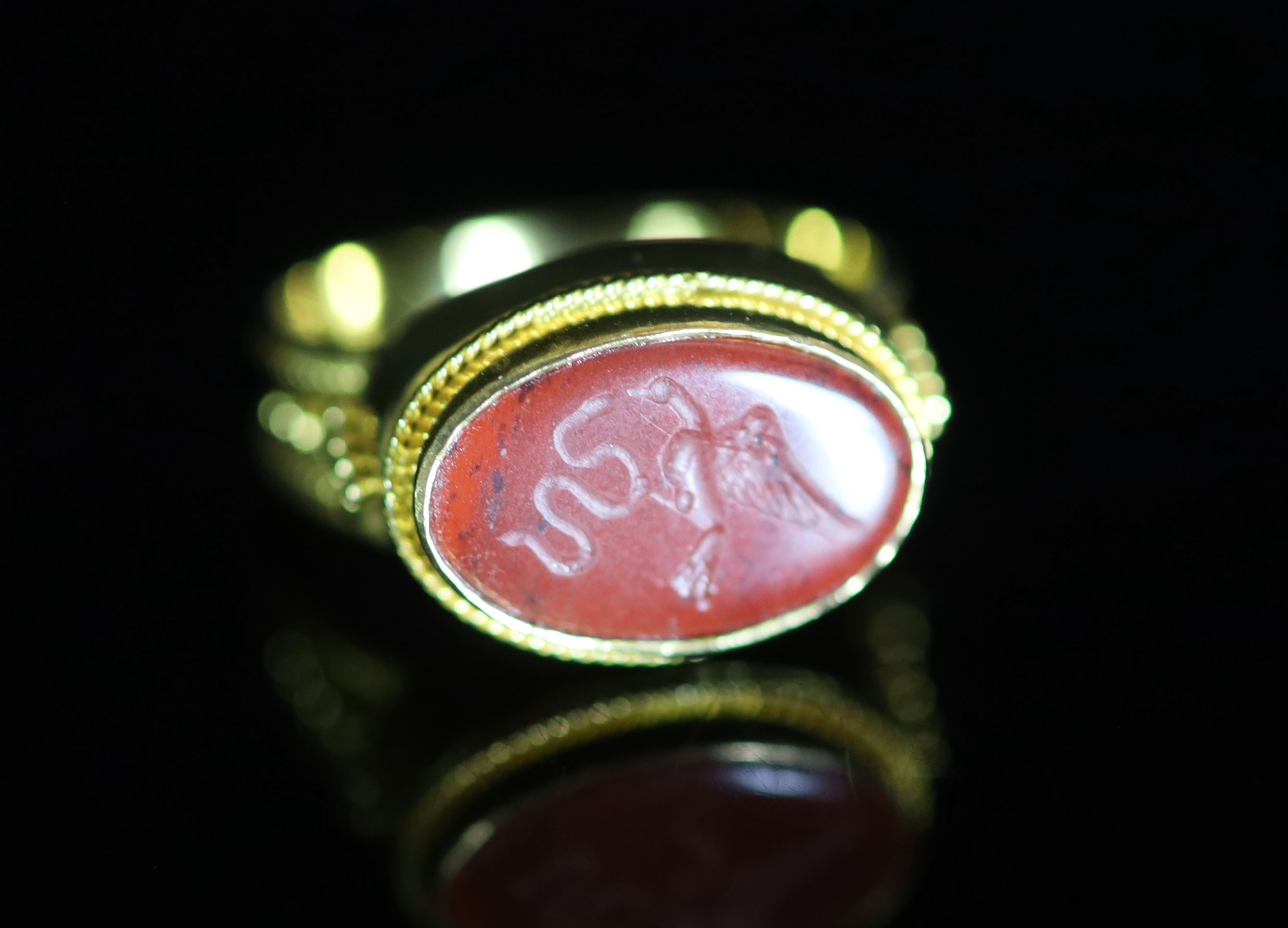 A Venetian 22ct gold and antique oval carnelian set signet ring